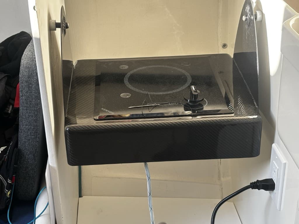 Flush-mount cooktop in a gloss carbon galley enclosure