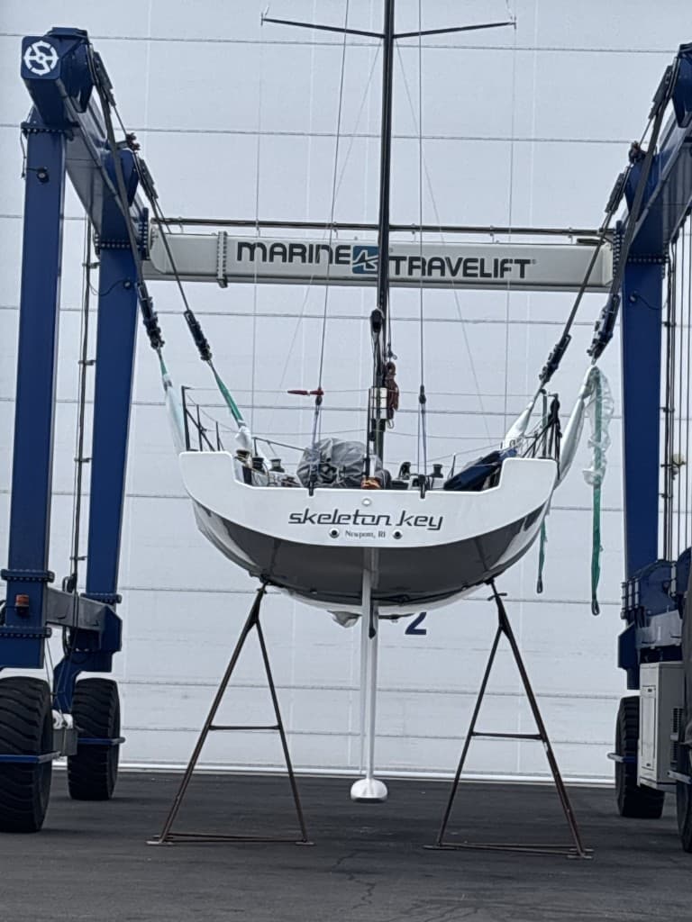 Sailboat suspended from a marine travel lift